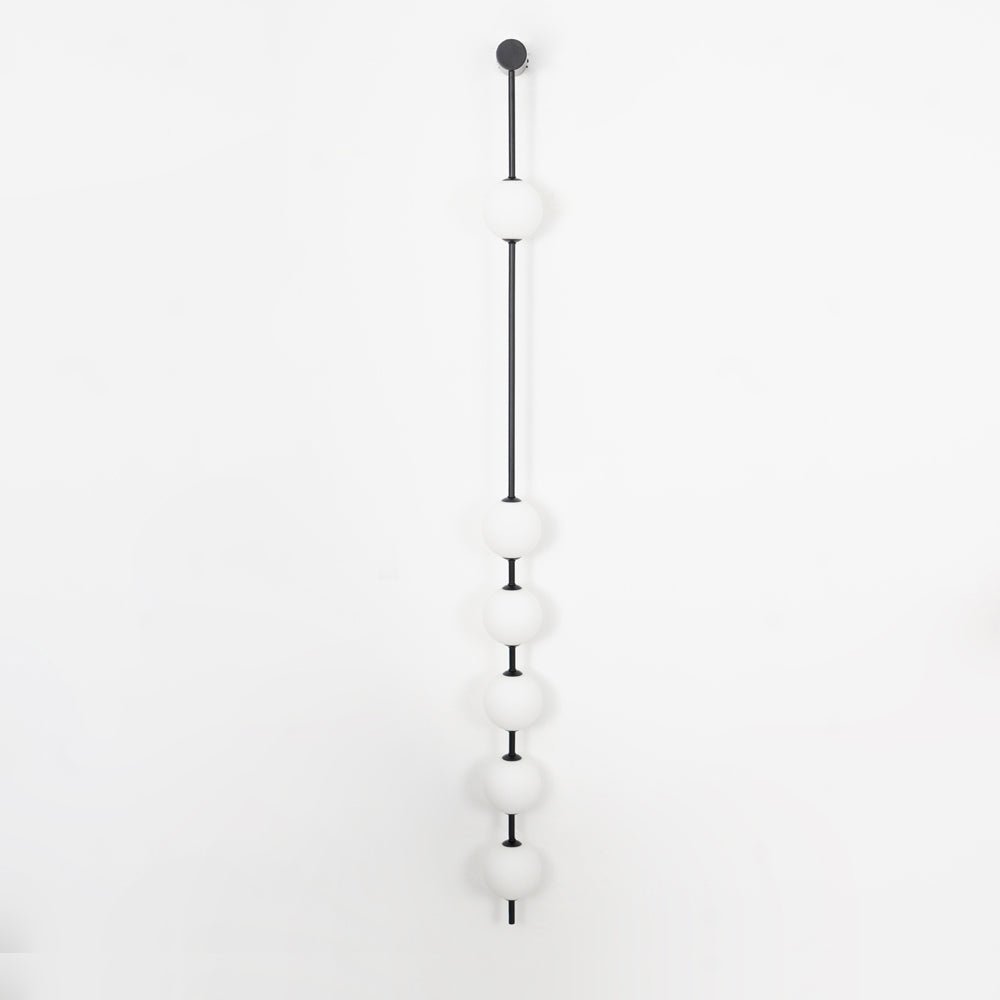 Soloiella wandlamp met verticale bollen van messing