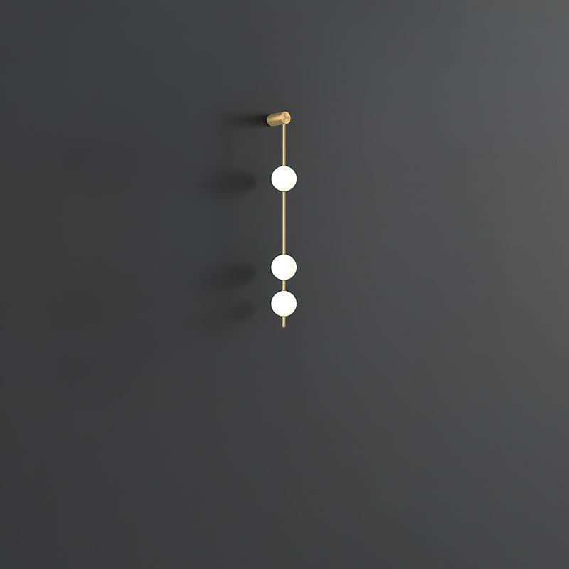 Soloiella wandlamp met verticale bollen van messing