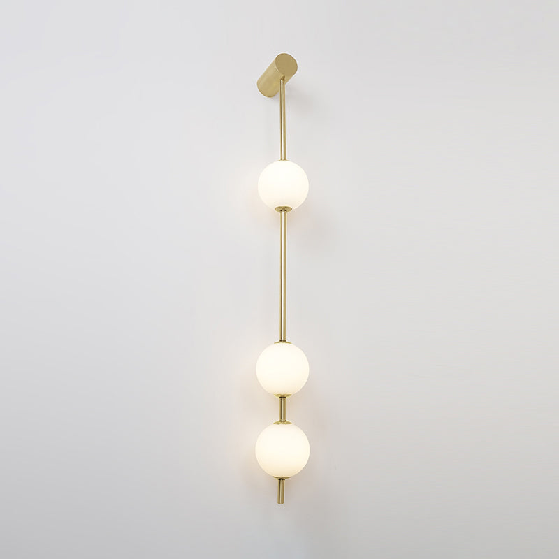 Soloiella wandlamp met verticale bollen van messing