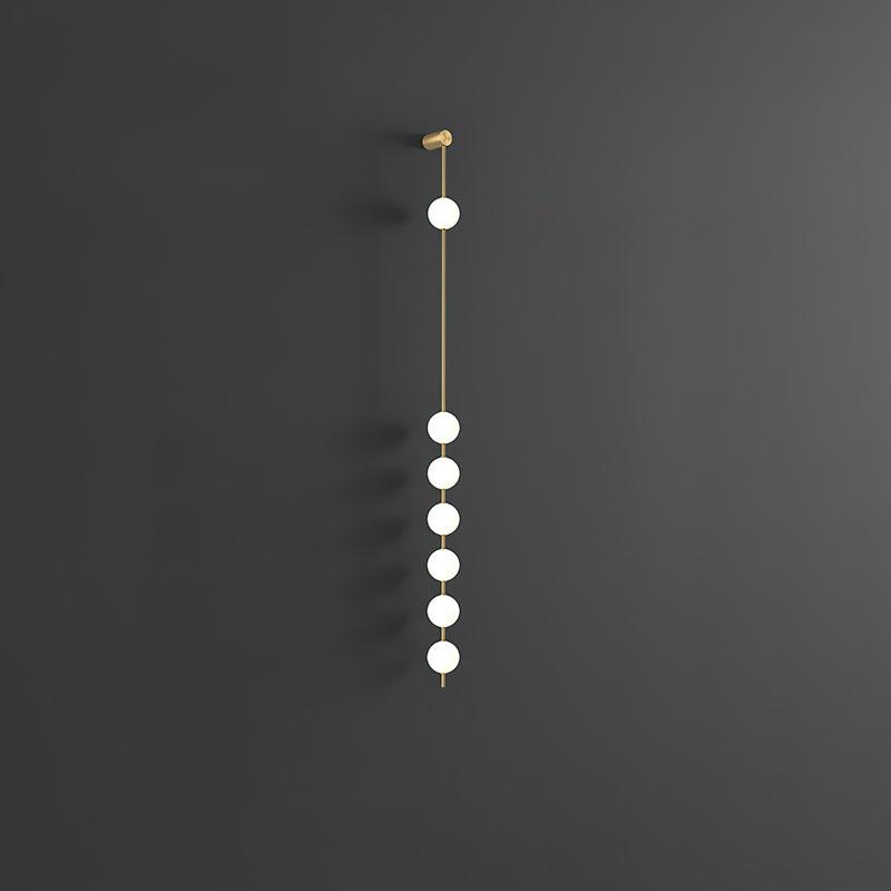 Soloiella wandlamp met verticale bollen van messing