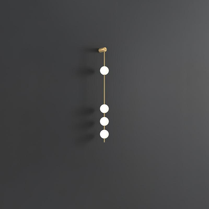 Soloiella wandlamp met verticale bollen van messing